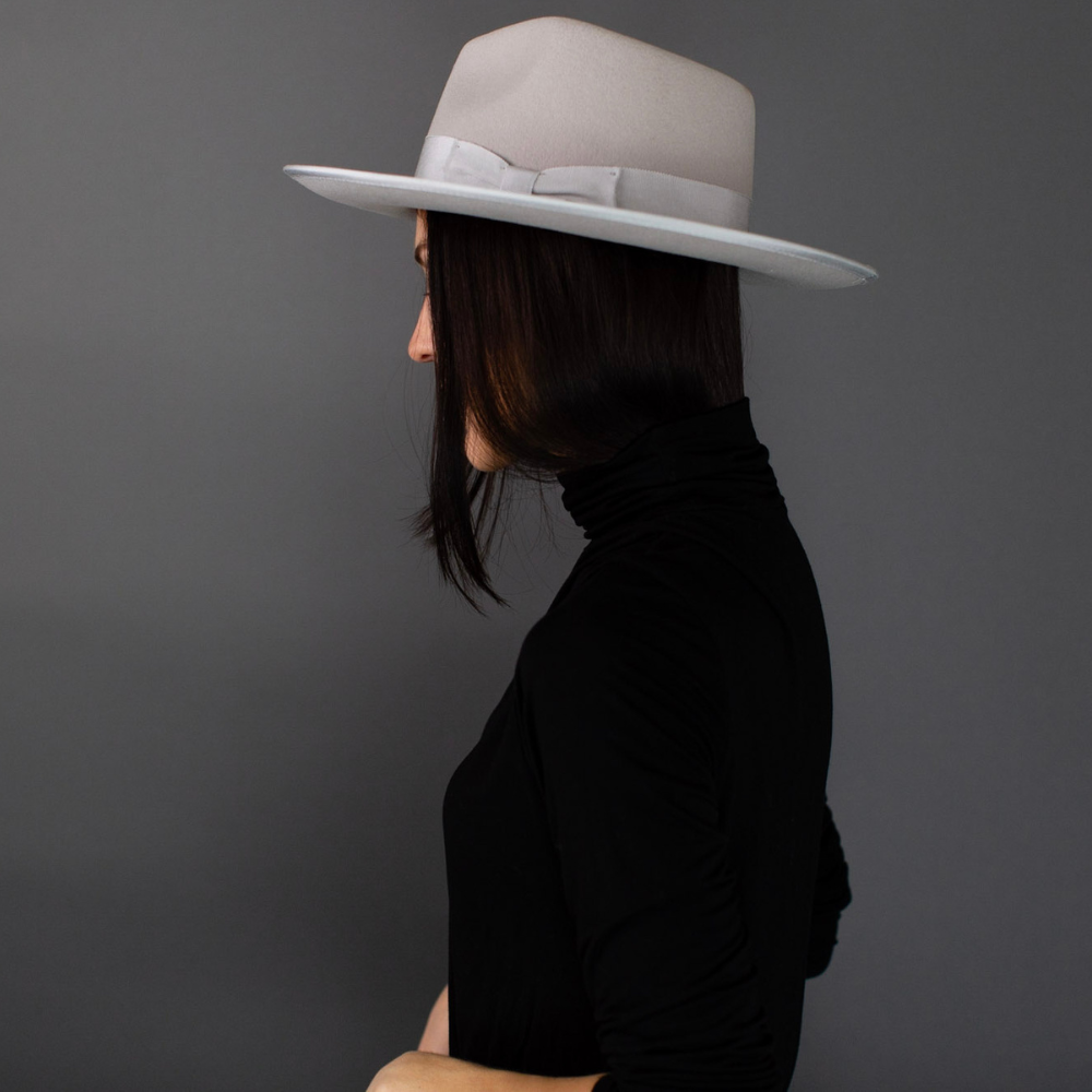 Introducing the Ivory Short Brim Fedora with Band, a stylish and versatile accessory for your fashion collection. This elegant fedora features a shorter brim and a chic band, adding a touch of class to any ensemble. With its timeless design, it's the ideal choice to enhance your style and make a statement on any occasion.