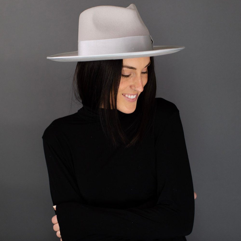 Introducing the Ivory Short Brim Fedora with Band, a stylish and versatile accessory for your fashion collection. This elegant fedora features a shorter brim and a chic band, adding a touch of class to any ensemble. With its timeless design, it's the ideal choice to enhance your style and make a statement on any occasion.