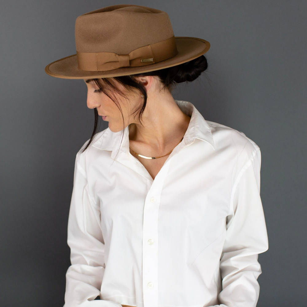 Presenting the Brown Wide Brim Fedora with Band, a symbol of timeless sophistication. This classic fedora showcases a wide brim and a tasteful band, effortlessly blending traditional charm with contemporary style. An essential accessory that exudes refinement, it's the perfect choice to elevate your fashion game for any occasion.