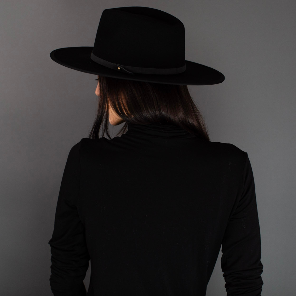 The Black Wide Brim Fedora with Leather Band, an embodiment of timeless sophistication. This elegant fedora features a wide brim and a sleek black leather band, combining classic style with modern sensibility. A versatile accessory that exudes refinement, it's the perfect choice to elevate your fashion game for any occasion.